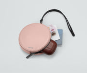 Circle Zip Pouch packed with earpods, credit cards, and money