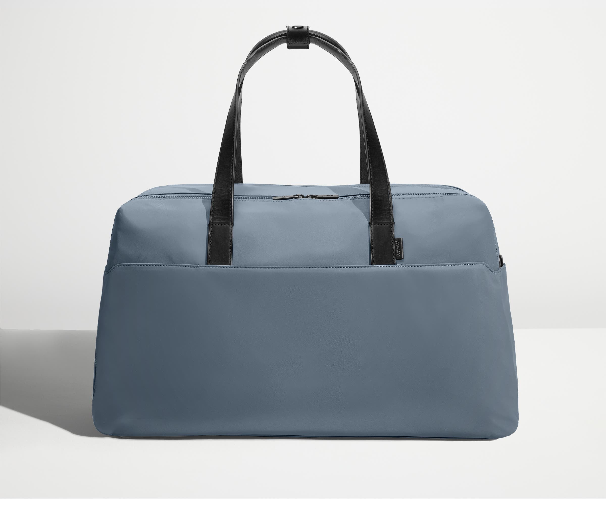 Front view of Away's Weekender duffle in Coast Blue with handles up