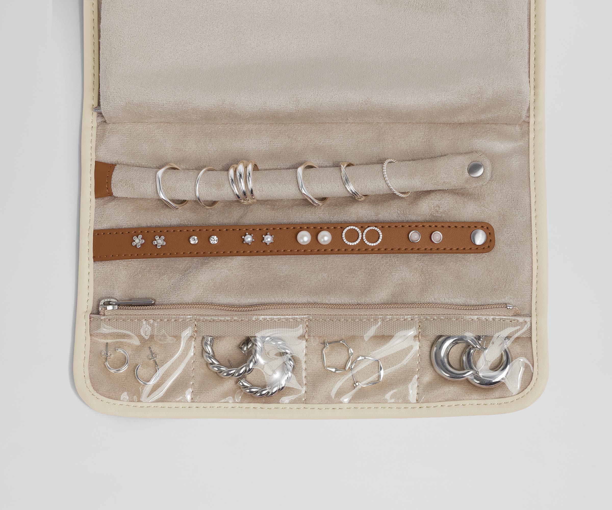Close up view of the compartments and two padded holders for earrings and rings
