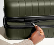 The Bigger Carry-On Flex suitcase in Olive Green has an additional wraparound zipper to expand the suitcase 2.25" (6 cm) and increase packing space