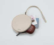 Circle Zip Pouch packed with earpods, credit cards, and money