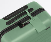 The leather luggage tag on top of a matching Away suitcase