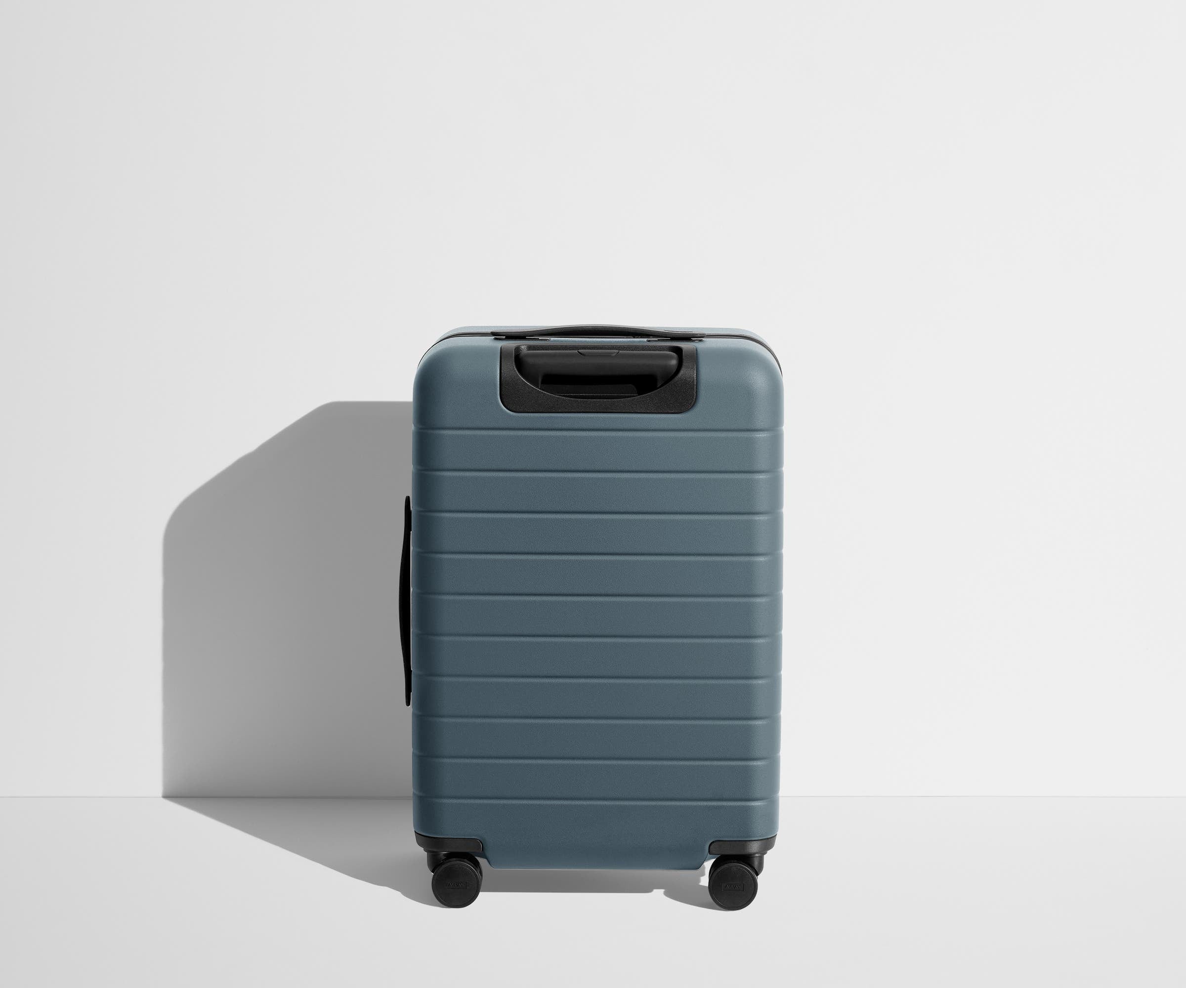 Back product view of The Bigger Carry-On suitcase in Coast Blue