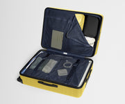 The Large suitcase in Sunshine Yellow shown open on its side and packed with Away's packing organizers to show capacity and the interior compression system, designed to help you pack more in