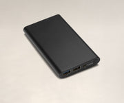 USB charger battery showing two USB-A ports, a micro-USB port, status lights, and a button to check the charge level.