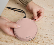 Person's hand holding the Circle Zip Pouch