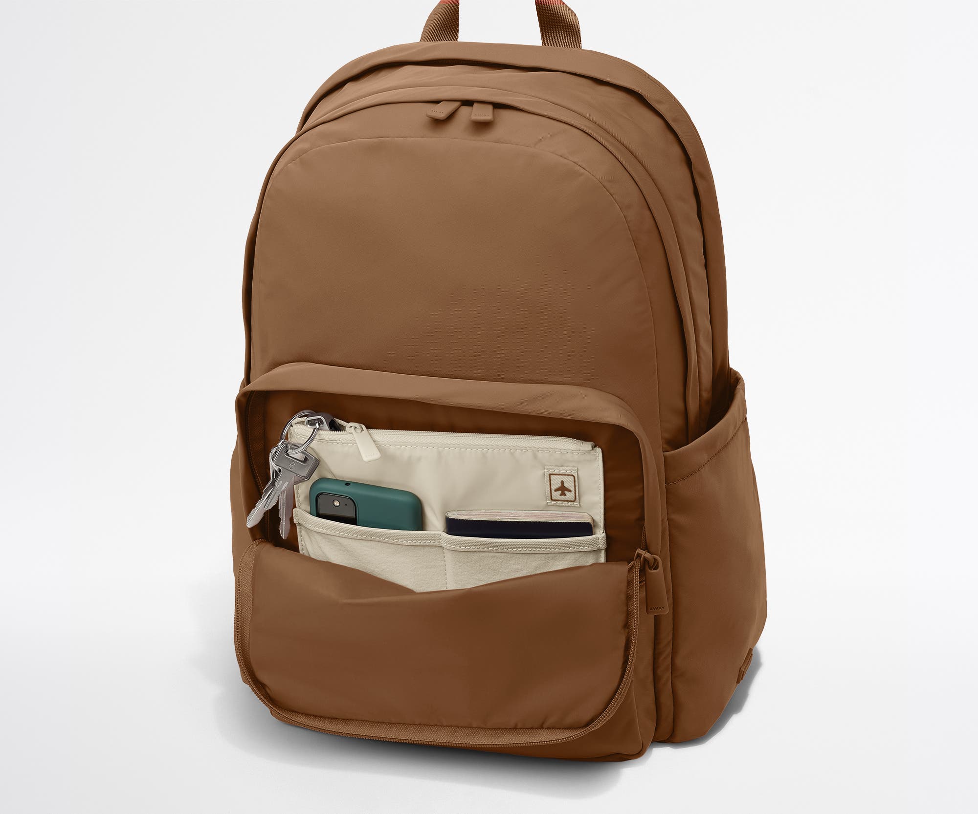 Phone, passport, and keys in their dedicated pockets in the front zip pocket