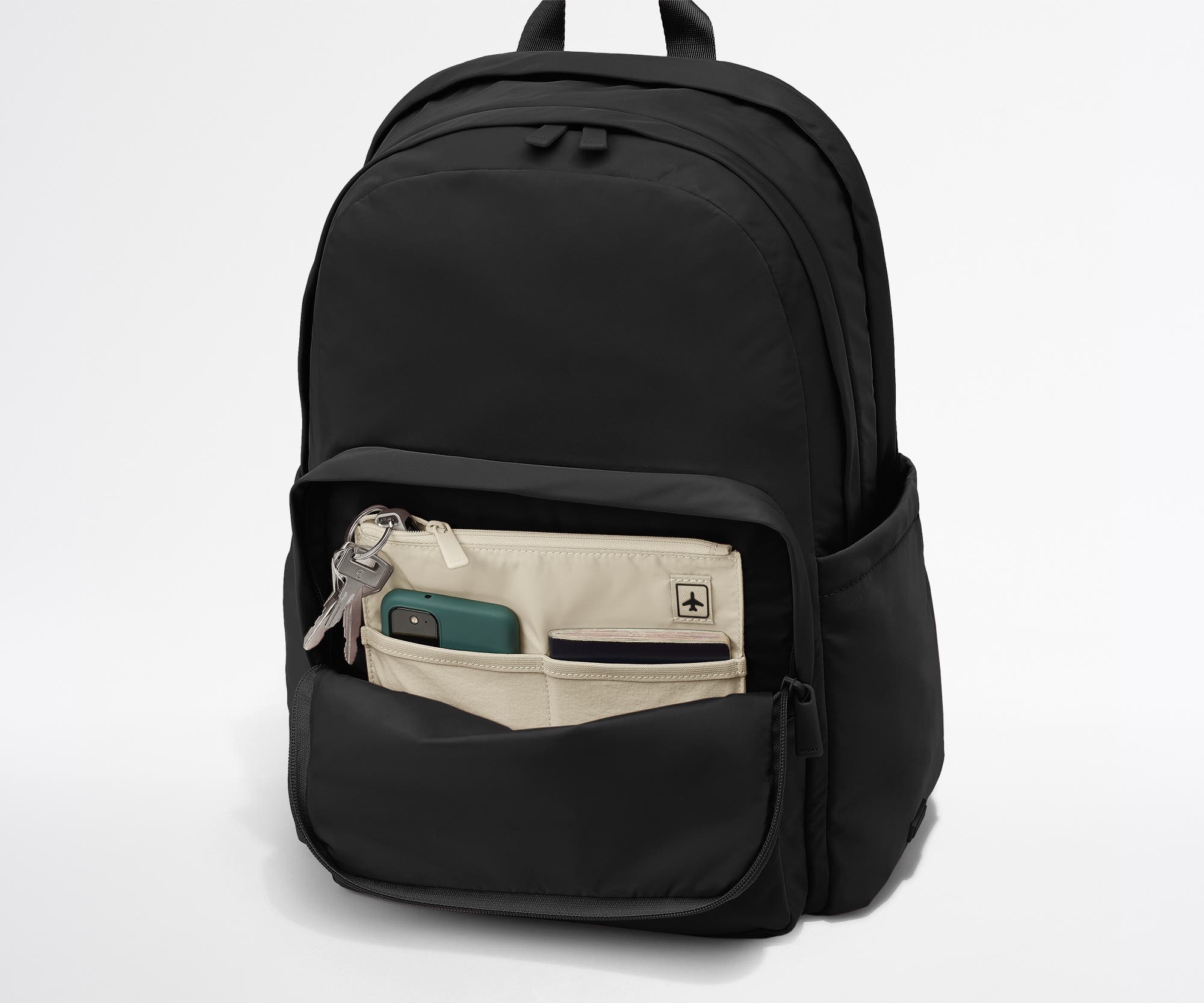 Phone, passport, and keys in their dedicated pockets in the front zip pocket