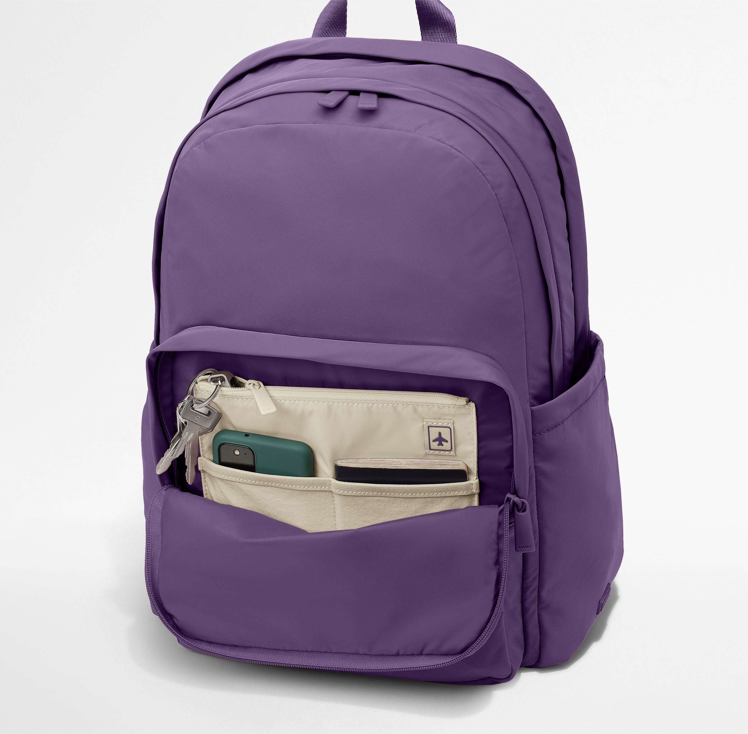 Phone, passport, and keys in their dedicated pockets in the front zip pocket