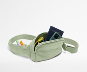 Sling Bag packed with a phone, passport, keys, and chapstick