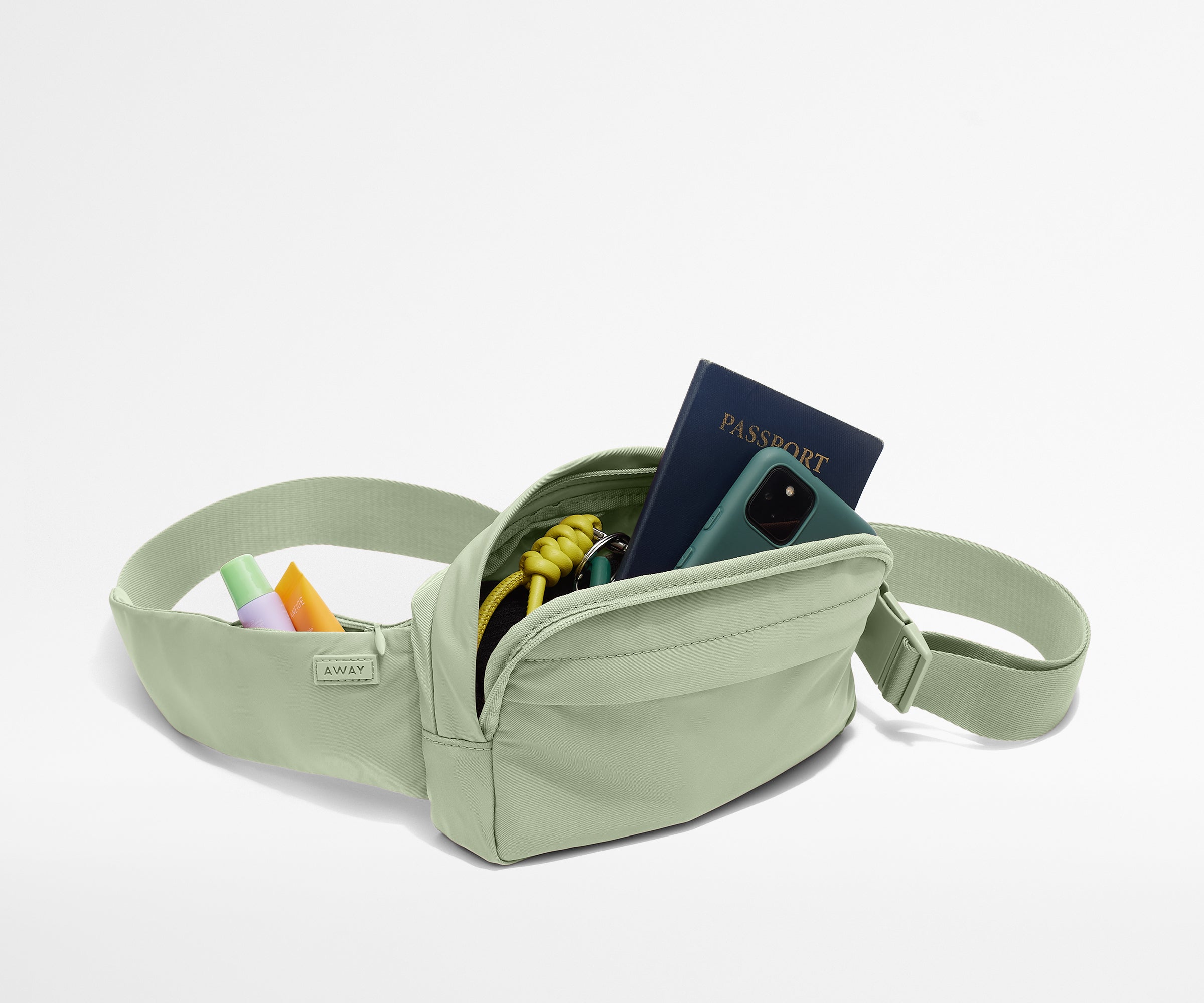 Sling Bag packed with a phone, passport, keys, and chapstick