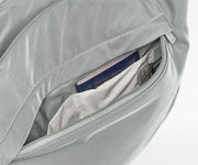 Gray bag with a pocket containing a passport and money on a white background