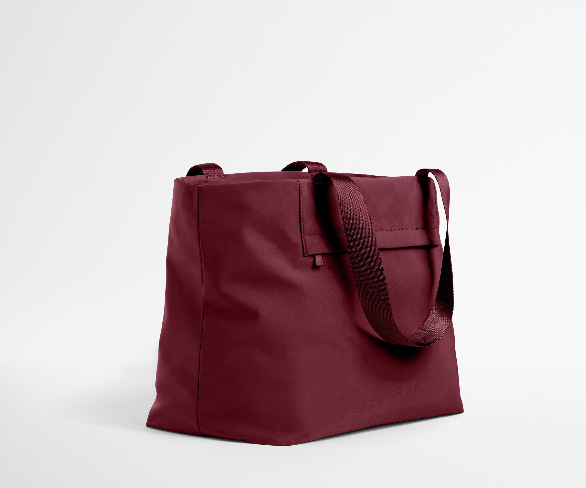 Maroon tote bag on a light gray background