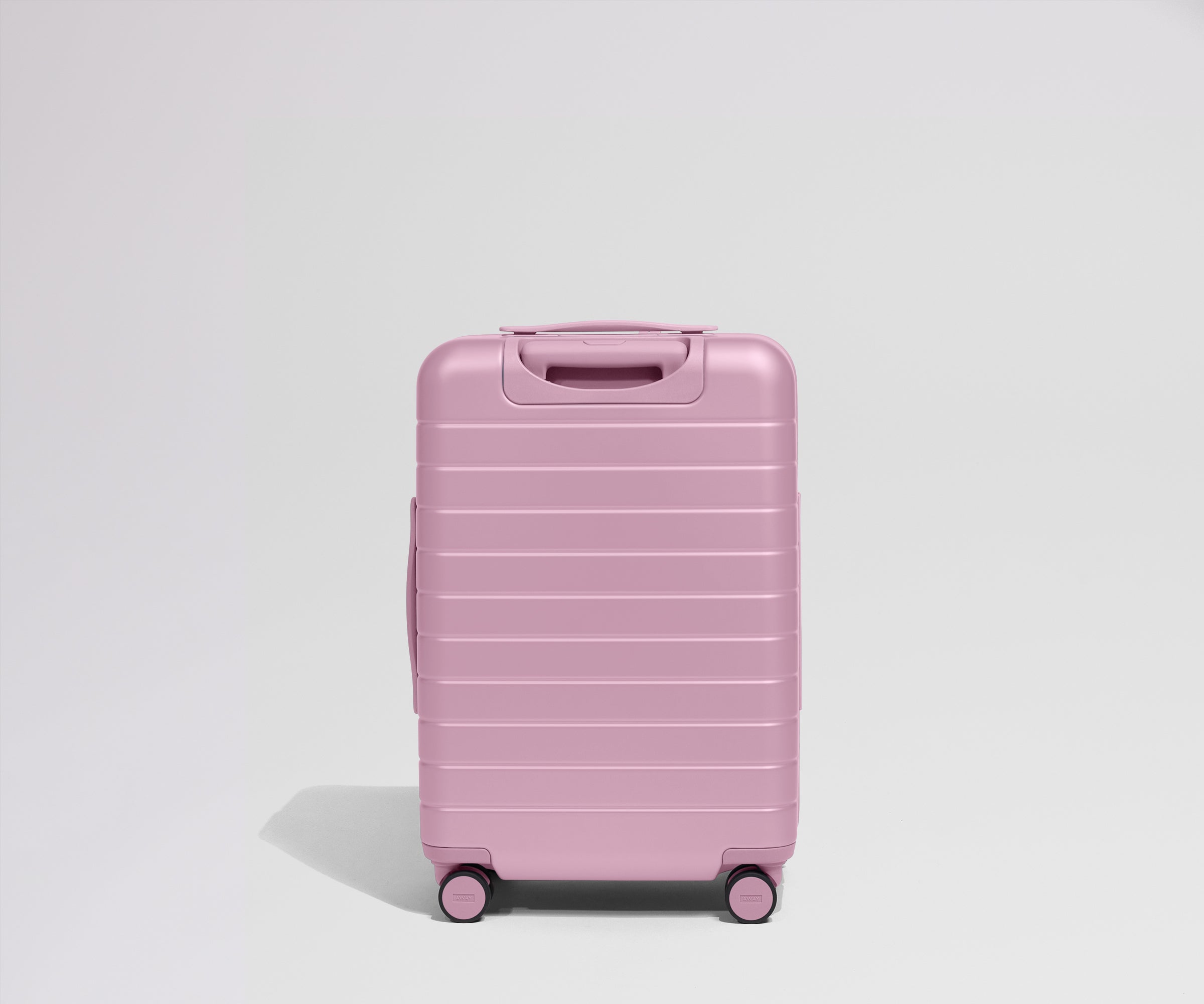 Pink suitcase on a light gray background