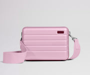 Pink crossbody bag on a light gray background