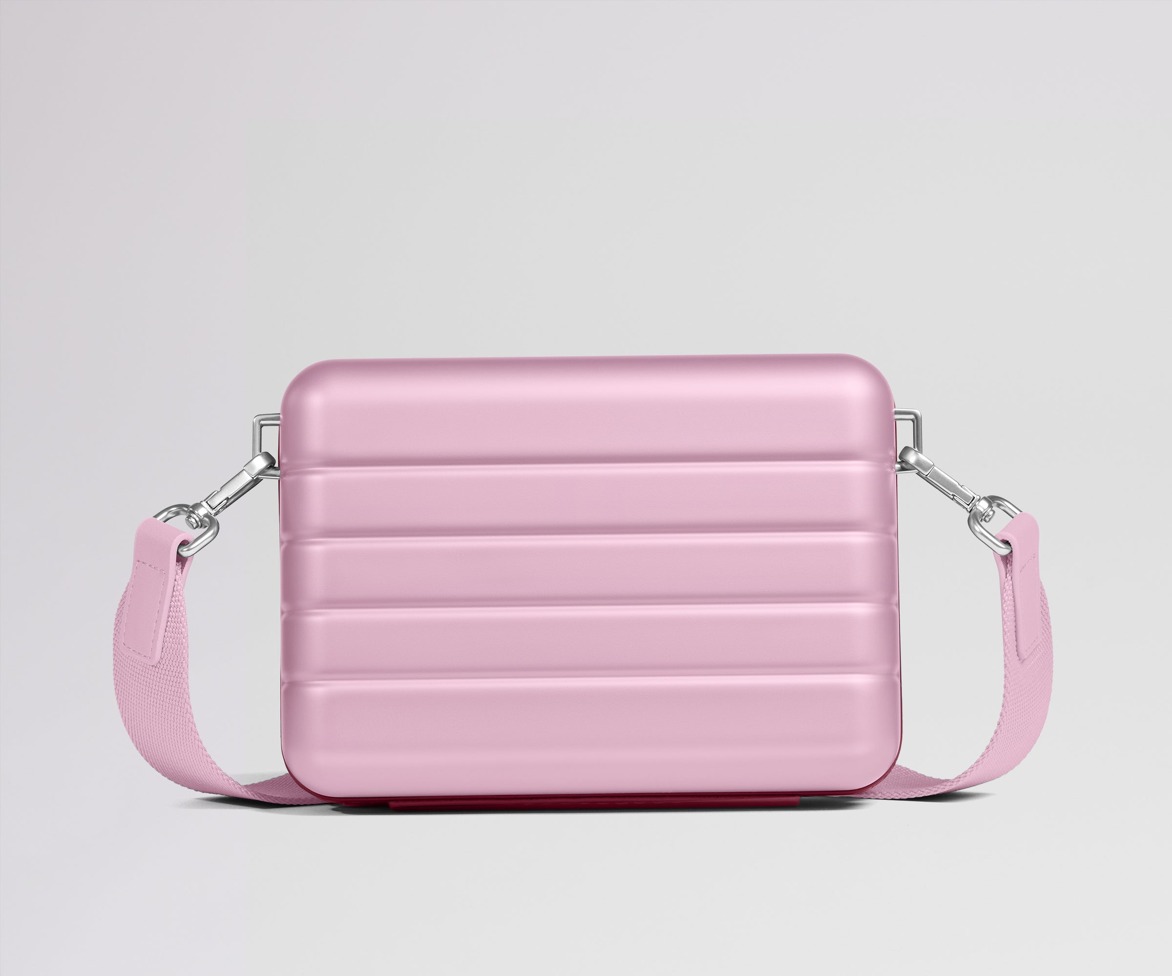 Pink crossbody bag on a light gray background