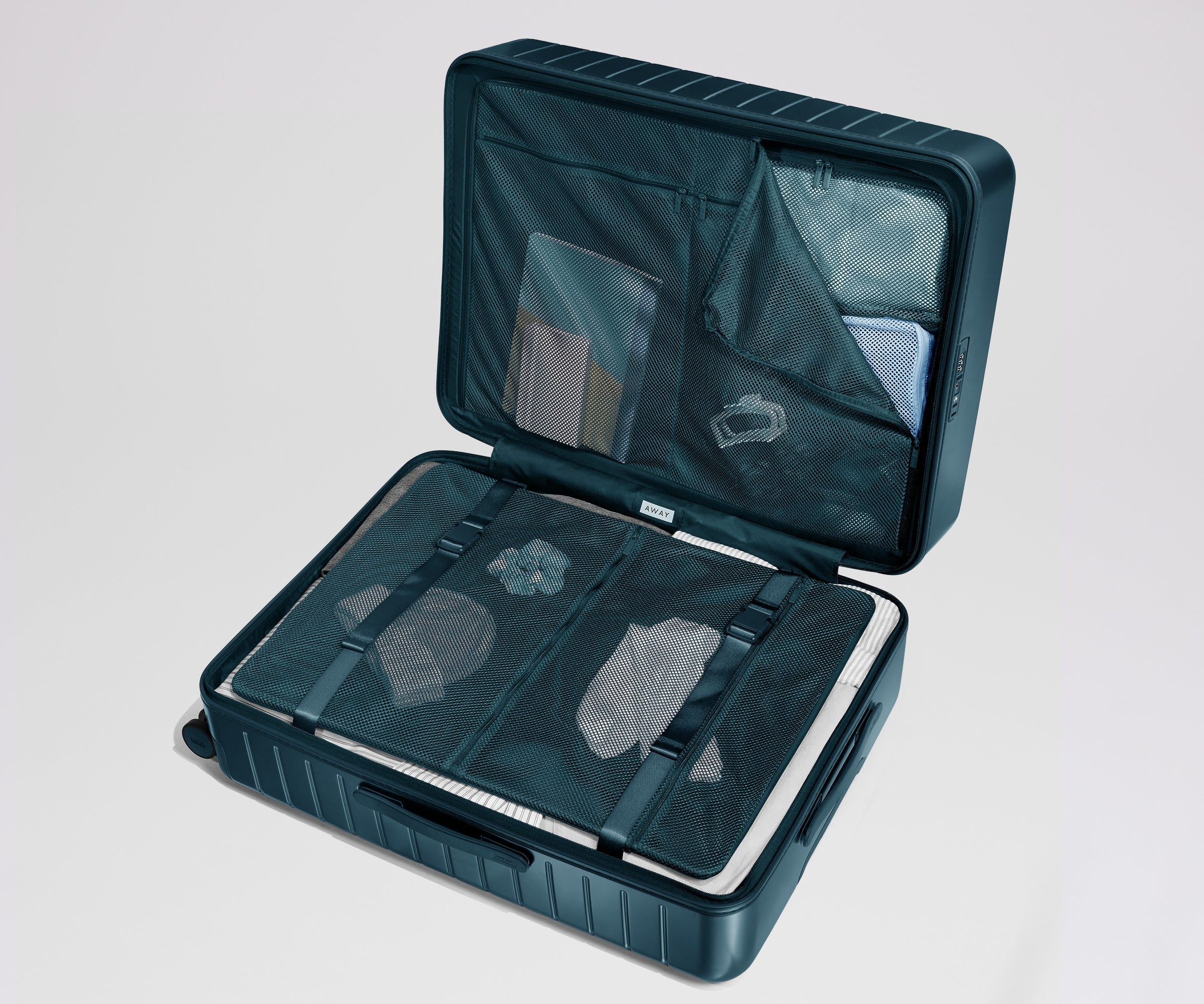 Open teal suitcase showing items inside on a light gray background