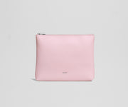 Pink pouch with an AWAY logo on a light gray background