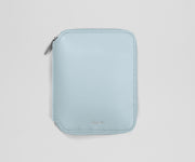 Light blue zippered jewelry organizer on a light gray background