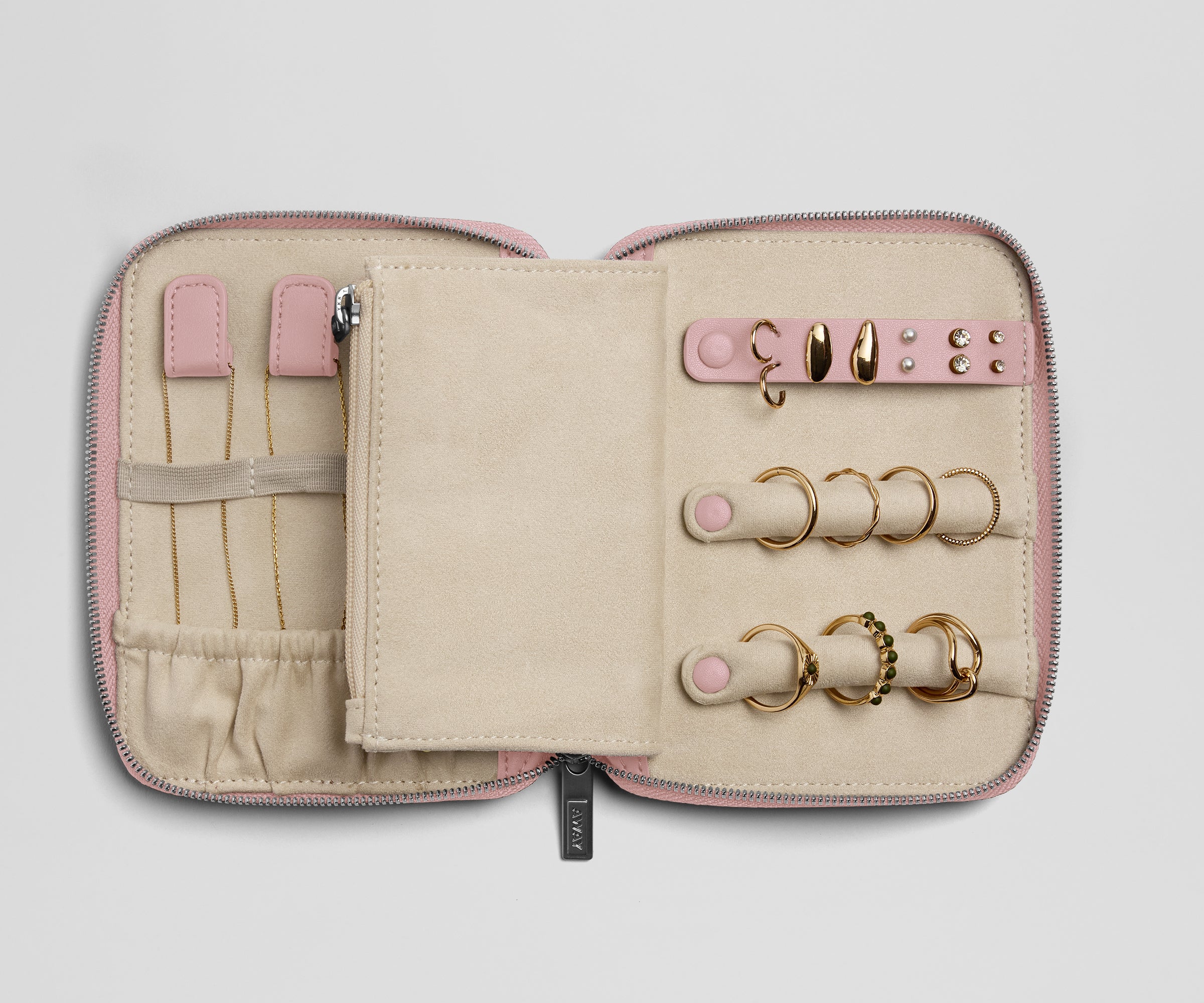 Pink jewelry case with gold rings on a light gray background