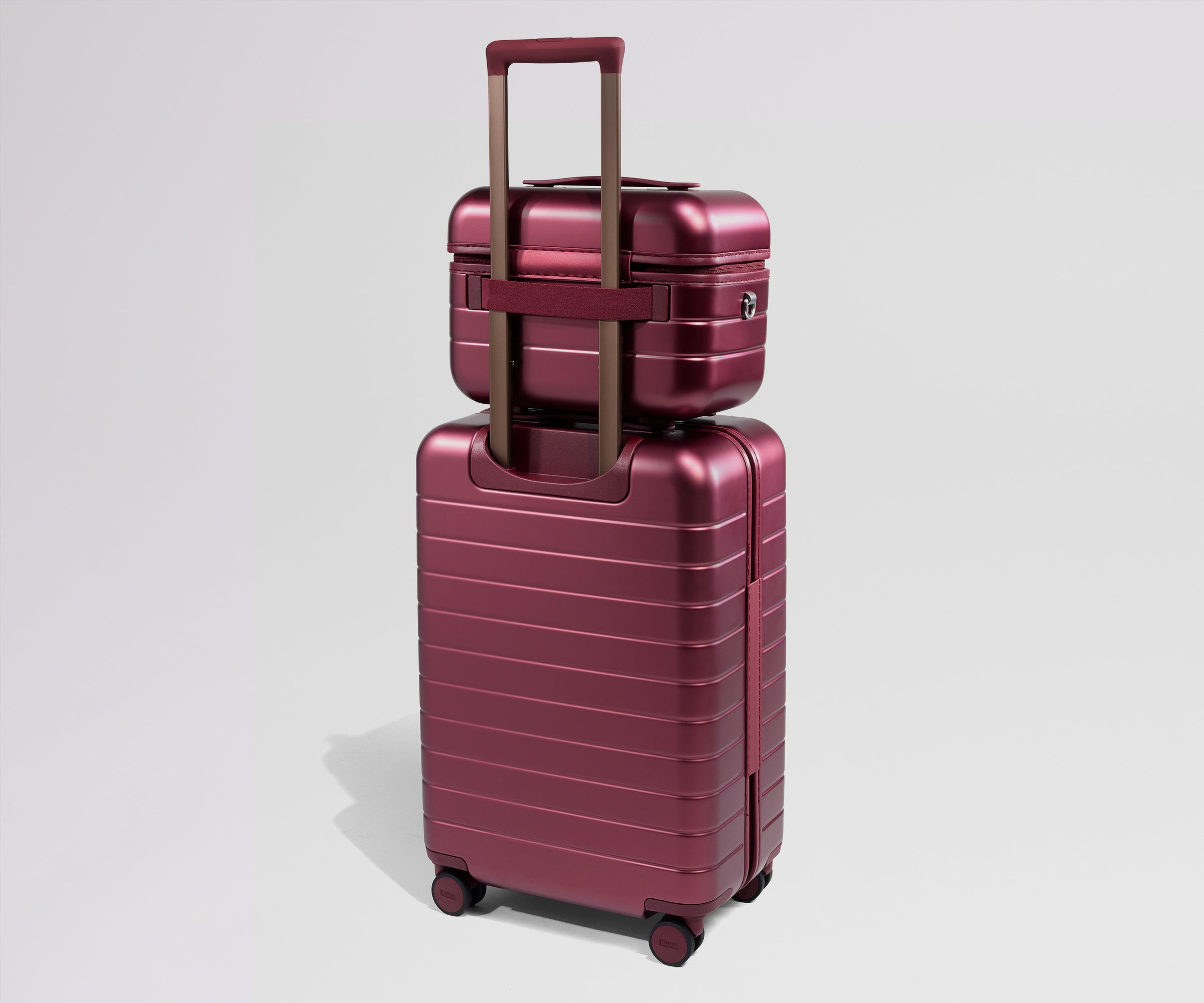 Red travel vanity case stacked on a matching suitcase