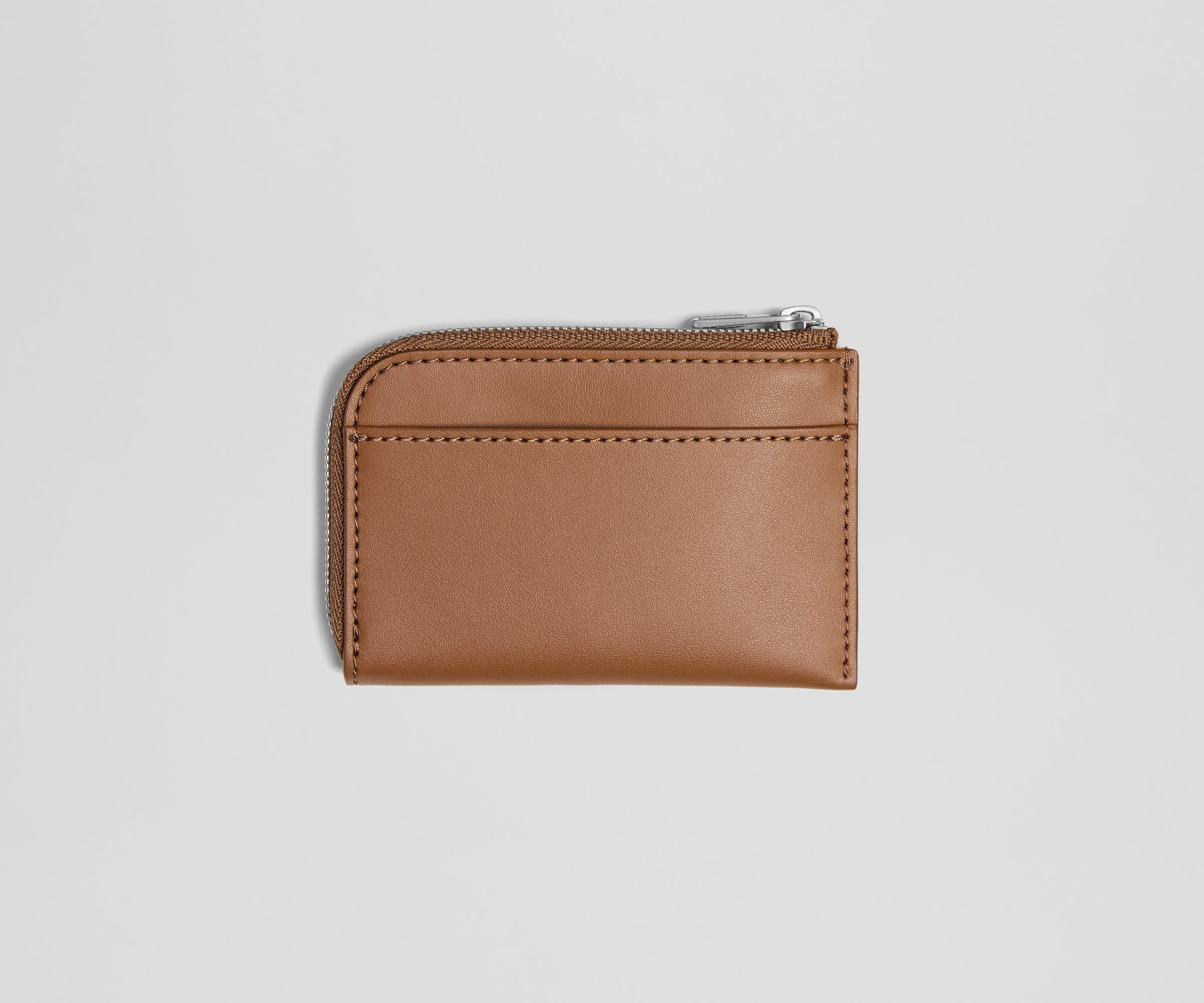 Brown leather wallet with a zipper on a light gray background