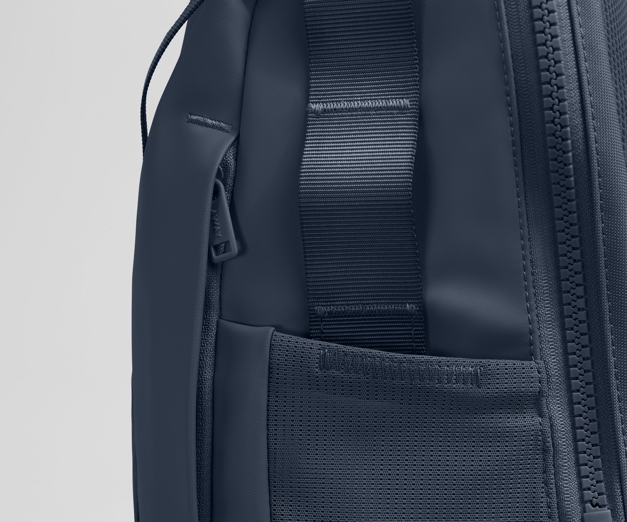 Close up view of the hidden zipper pocket, water bottle pocket, and side webbing loops