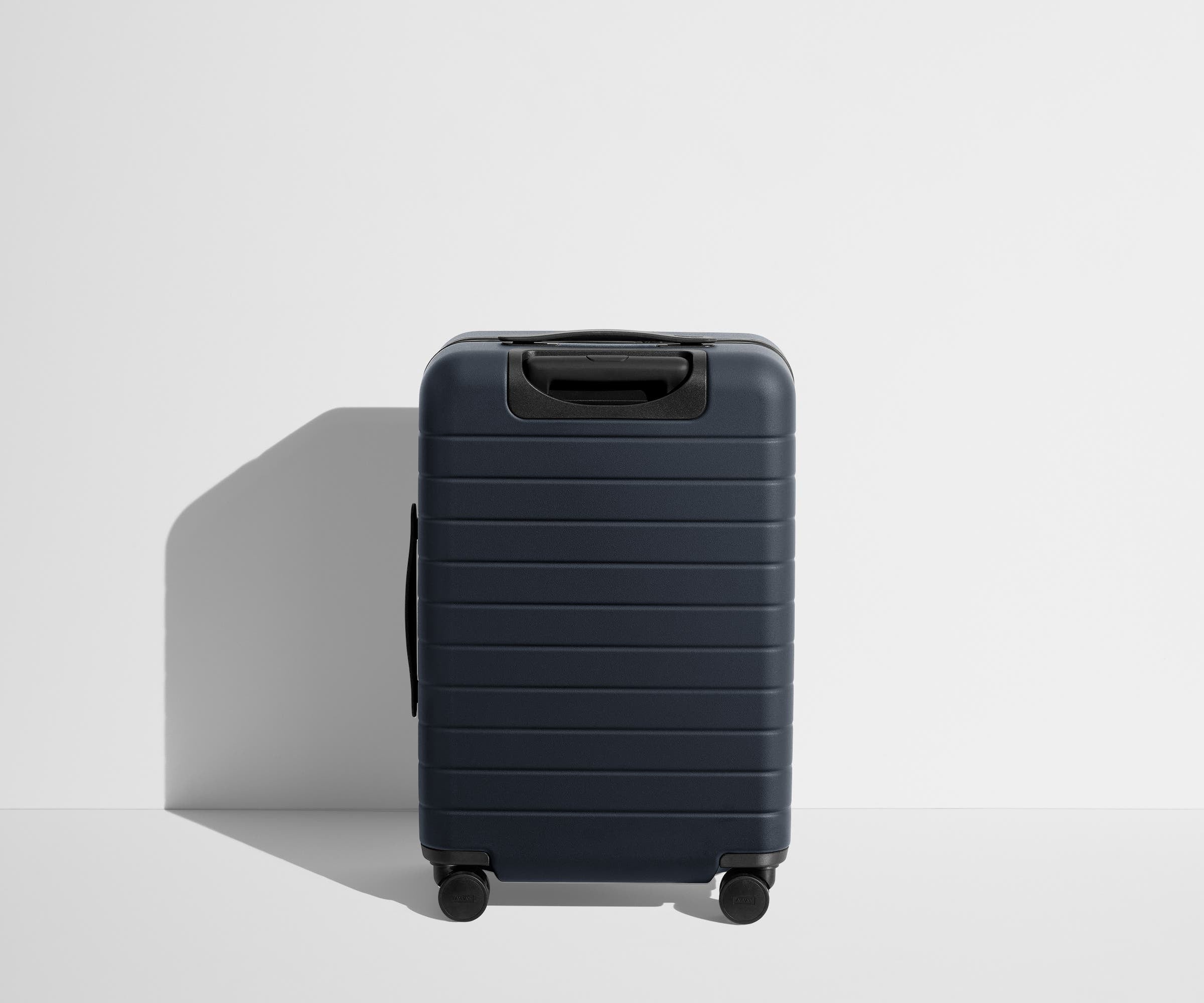 Back product view of The Bigger Carry-On Flex suitcase in Navy Blue