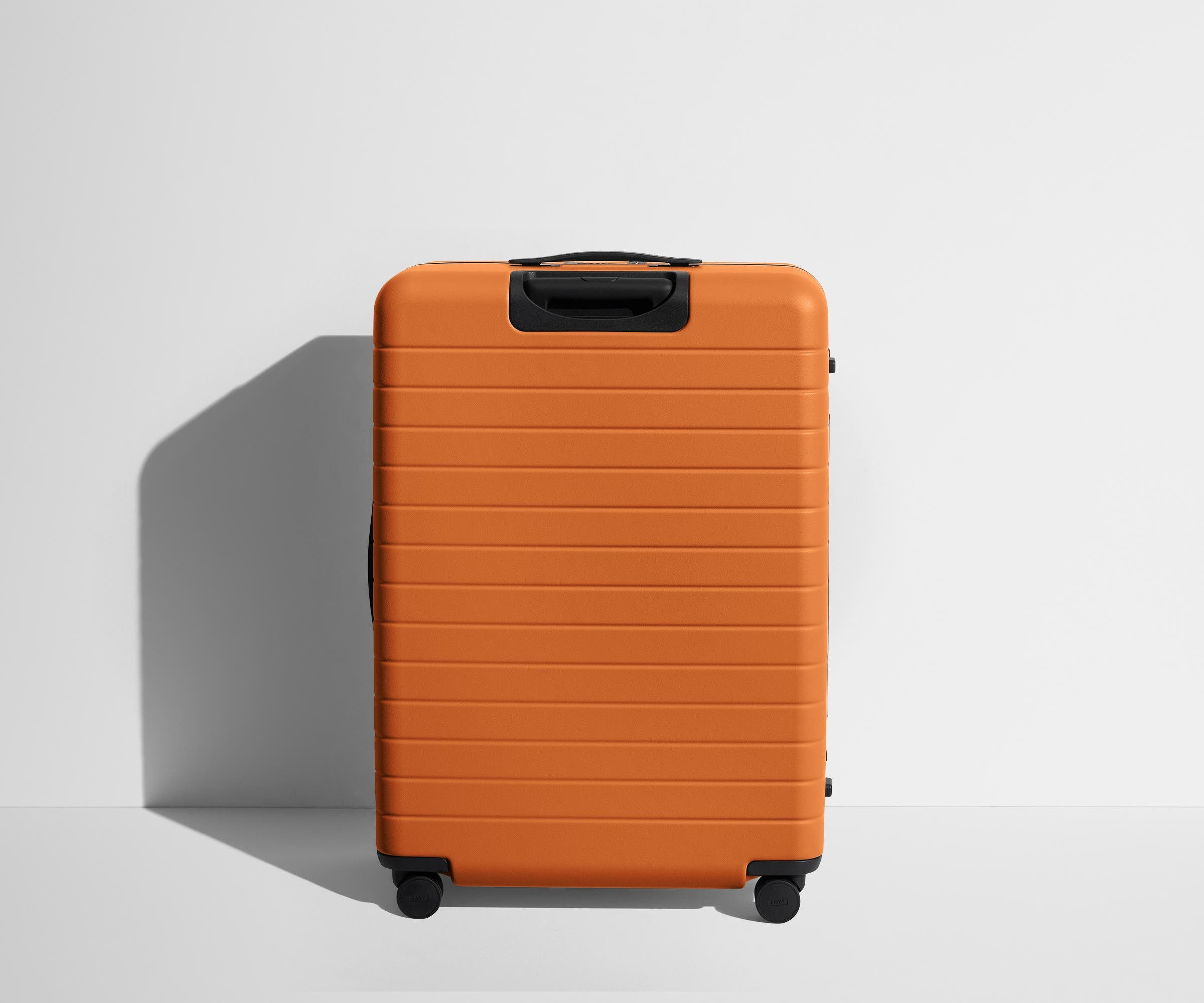 Back product view of The Large Flex suitcase in Sorbet Orange
