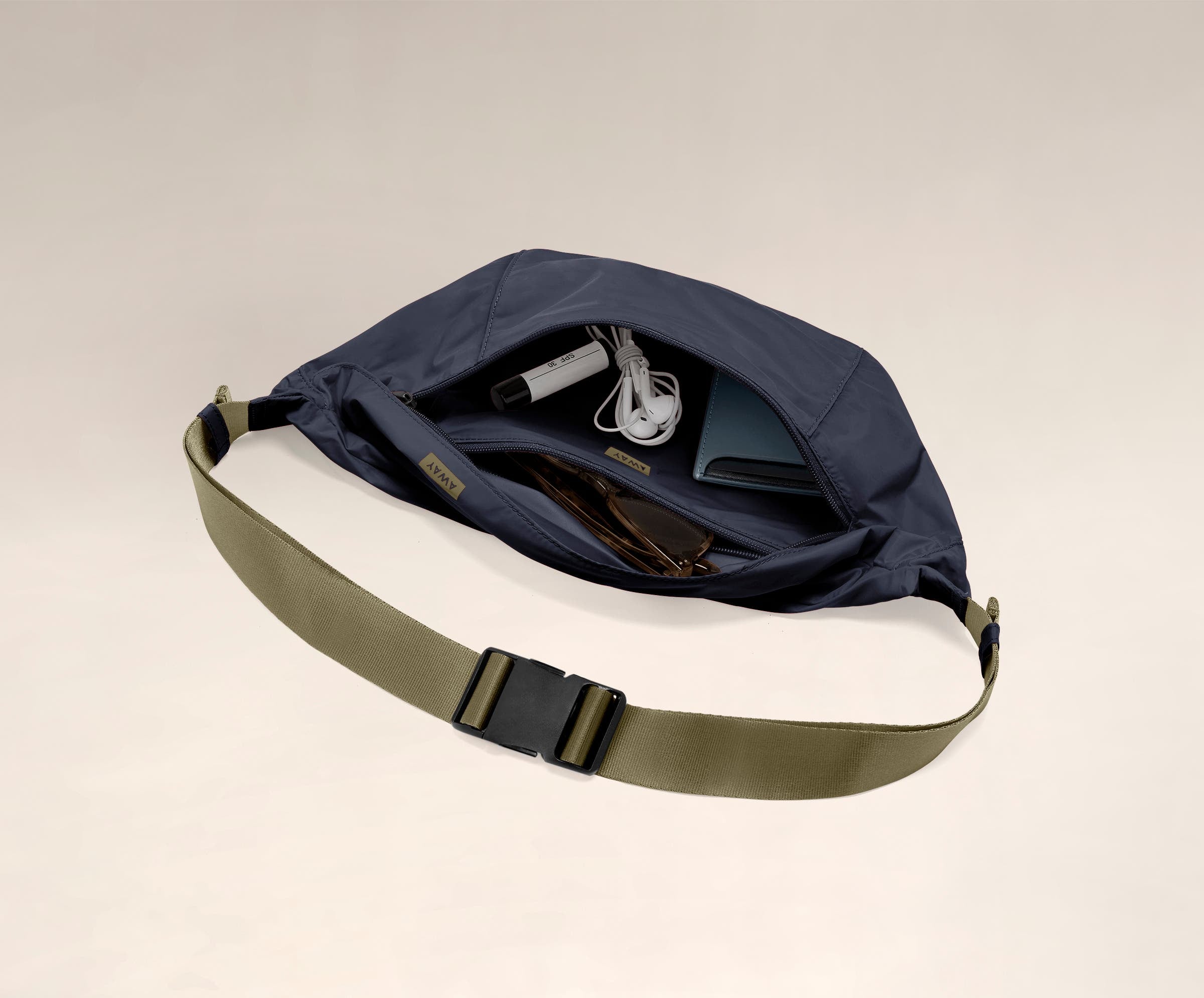 Main compartment packed with a wallet, headphones, and sunglasses