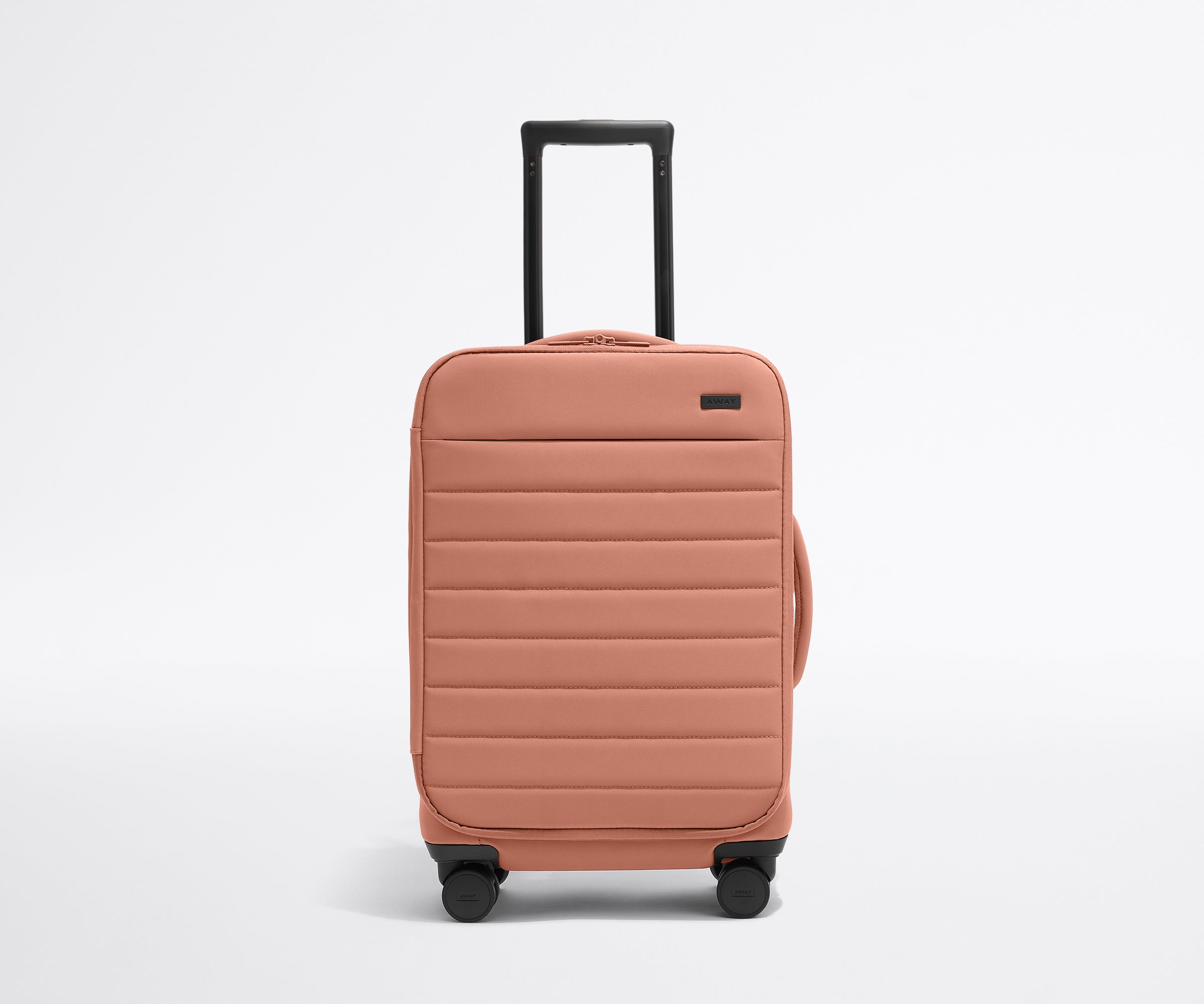 Front product view of The Softside Carry-On suitcase in Clay Pink with raised handle