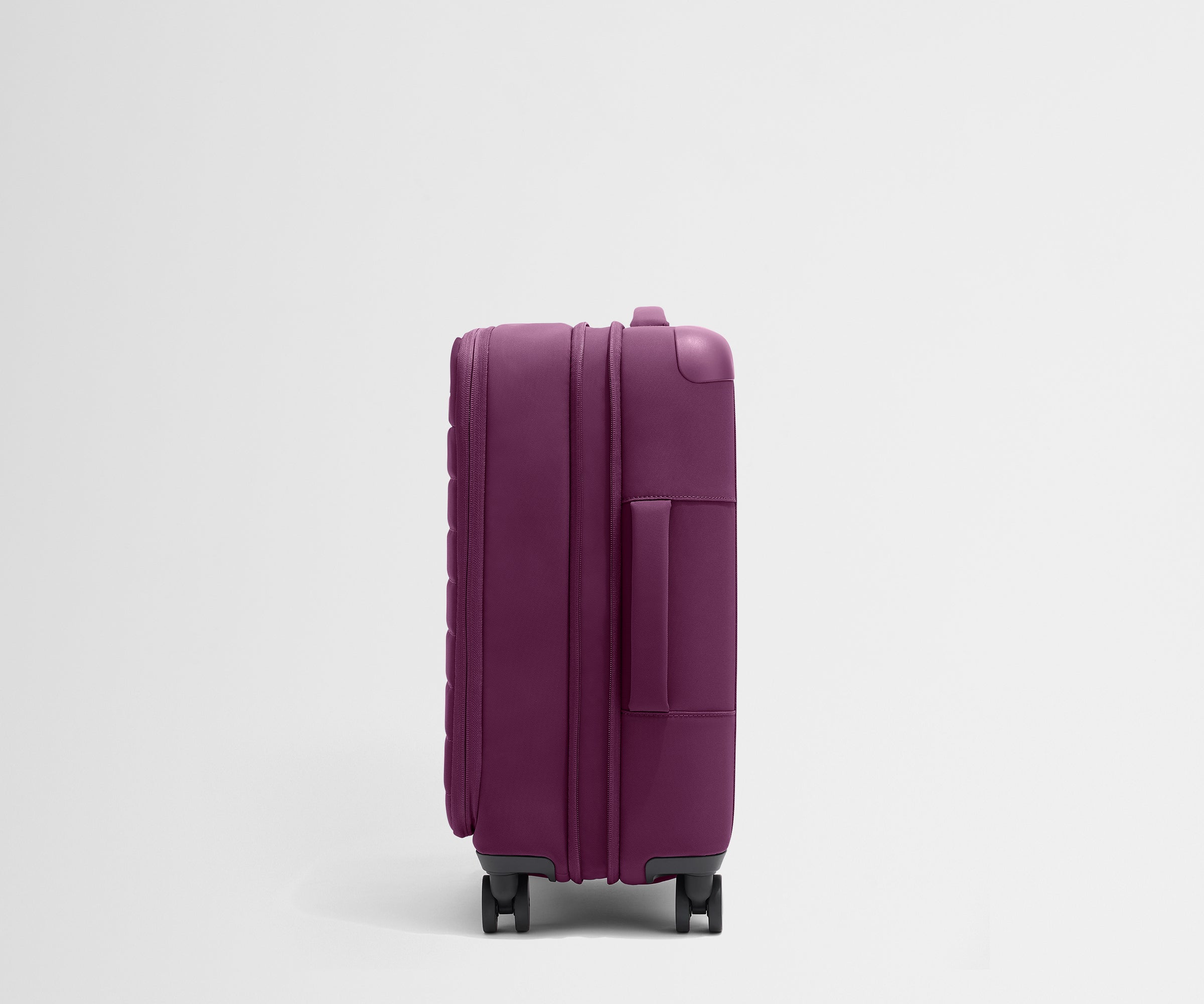 Side product view of The Softside Carry-On suitcase in Plum Purple shown fully expanded