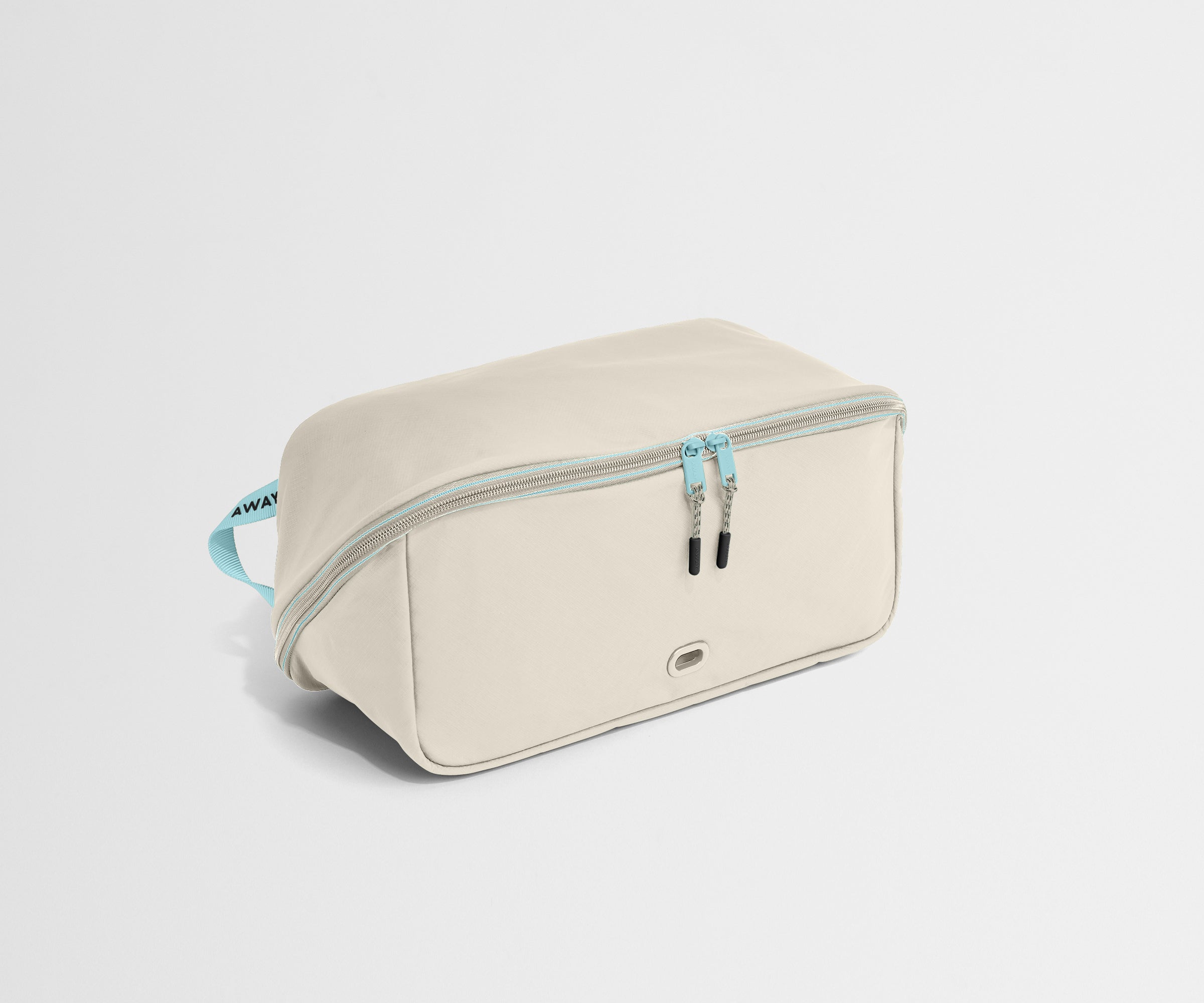 Beige shoe bag with a blue zipper on a light gray background