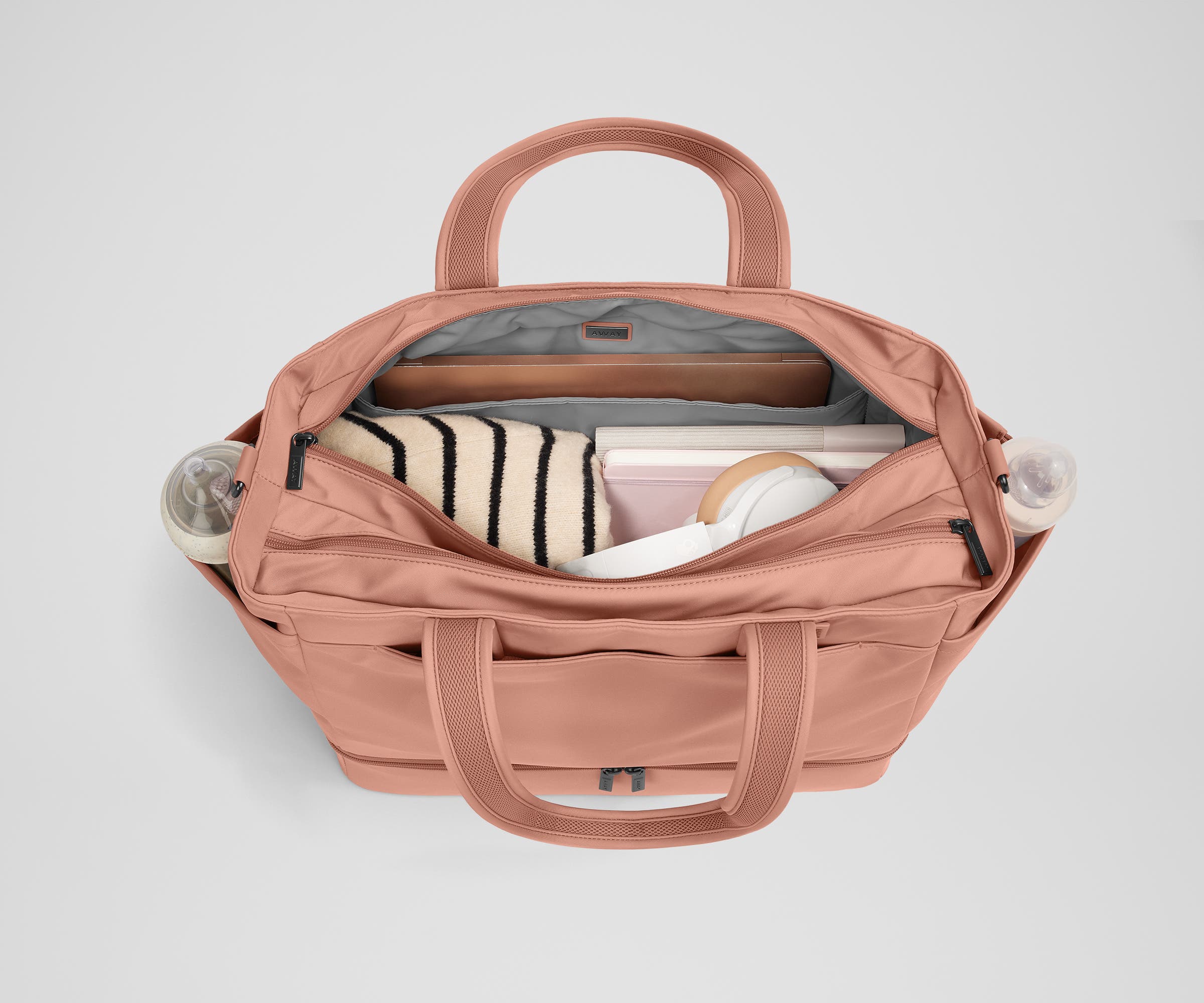 Back main compartment packed with adult travel essentials, including a laptop, notebook, and extra clothes