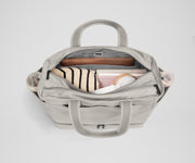 Back main compartment packed with adult travel essentials, including a laptop, notebook, and extra clothes