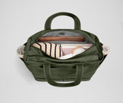 Back main compartment packed with adult travel essentials, including a laptop, notebook, and extra clothes