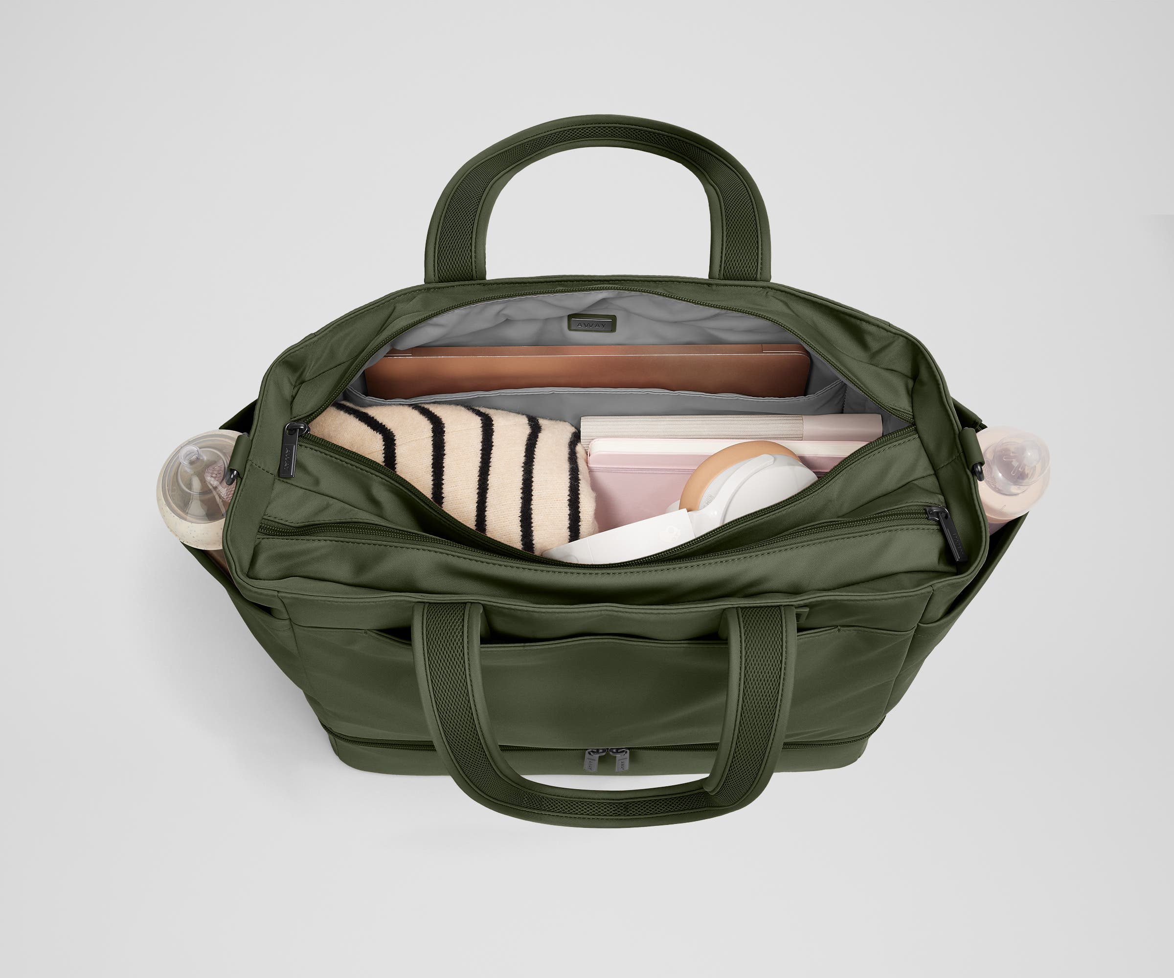 Back main compartment packed with adult travel essentials, including a laptop, notebook, and extra clothes