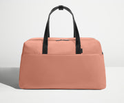 Front view of Away's Weekender duffle in Clay Pink with handles up