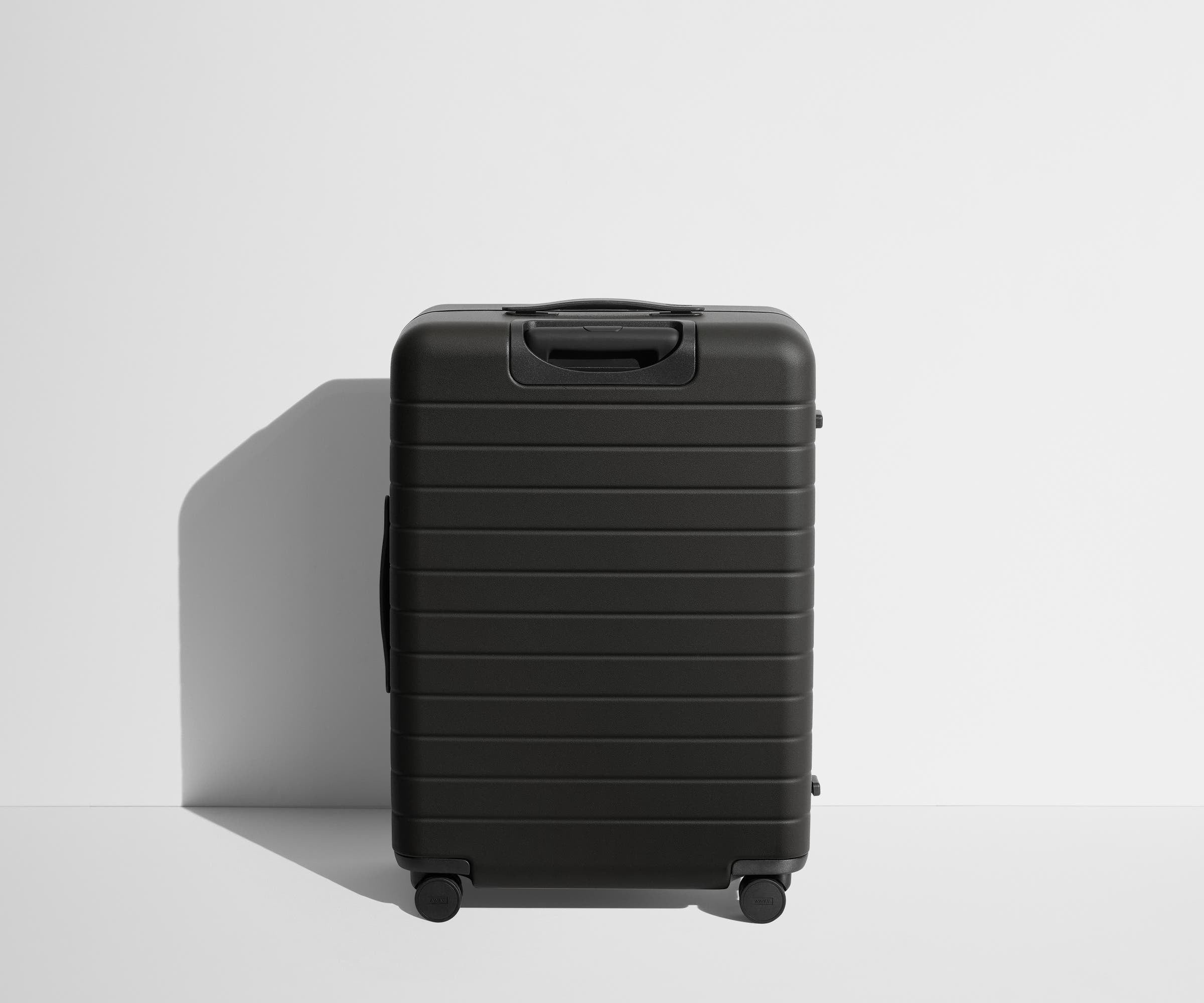 Back product view of The Medium suitcase in Jet Black
