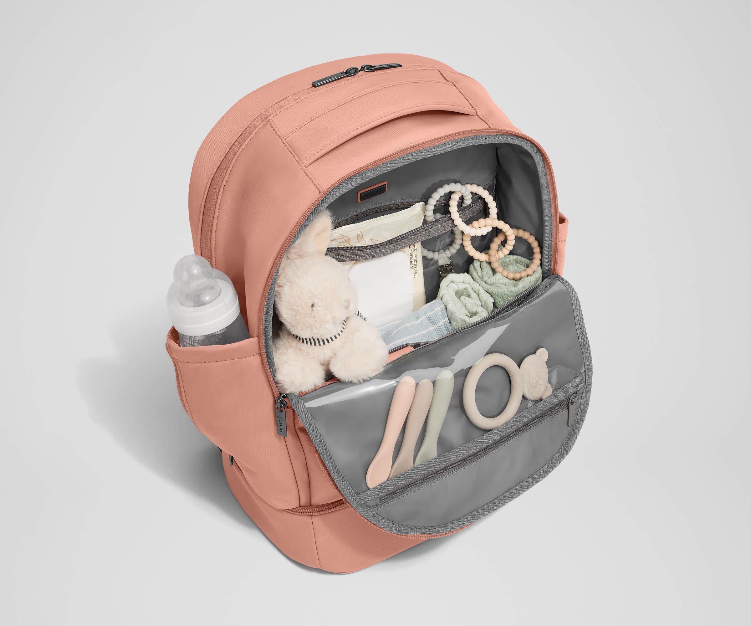 Front main compartment packed with child essentials, including a stuffed animal, wipes, and change of clothes