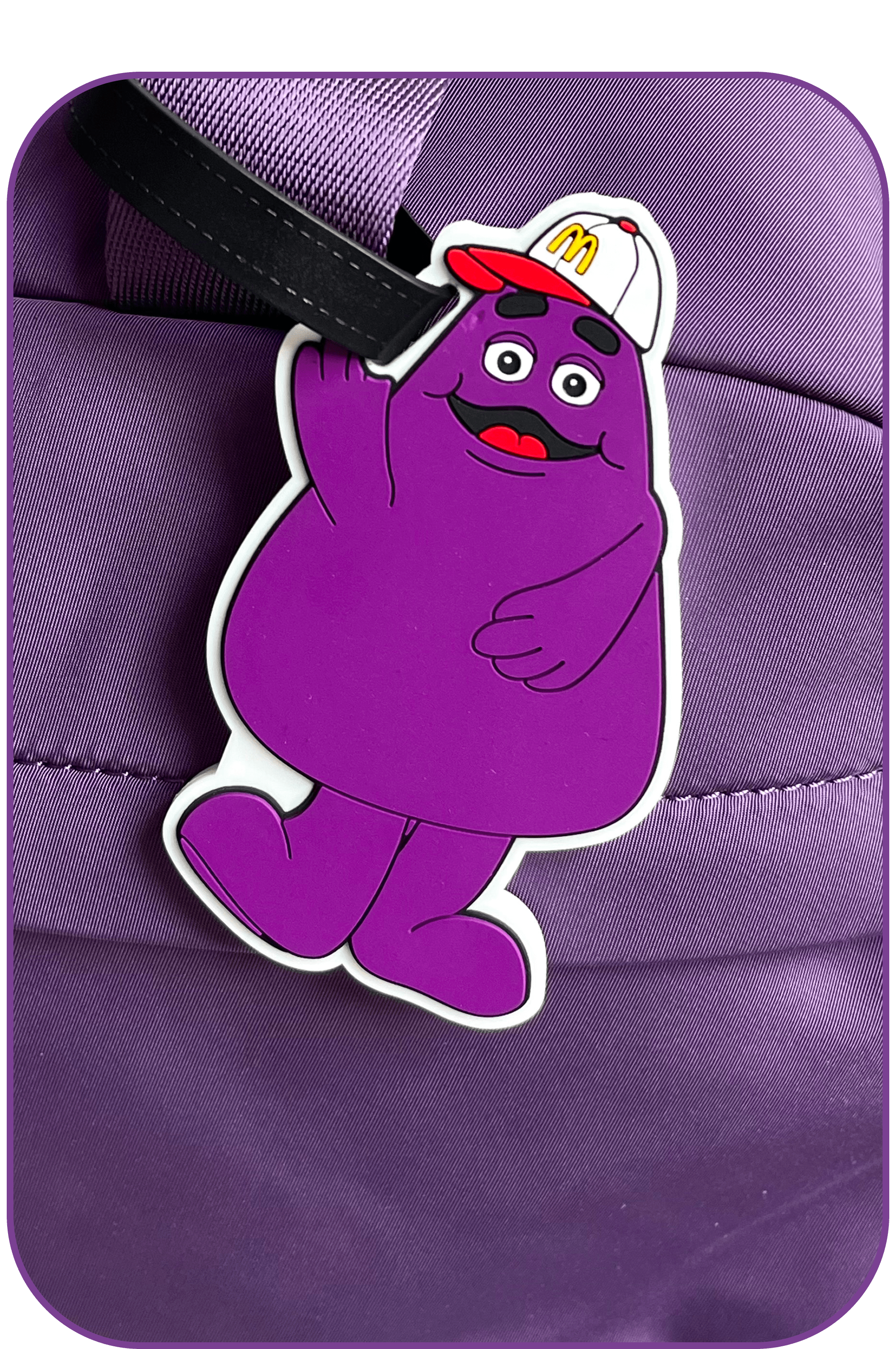 A Grimace luggage charm: Checked three bags. Didn’t check the weather.
