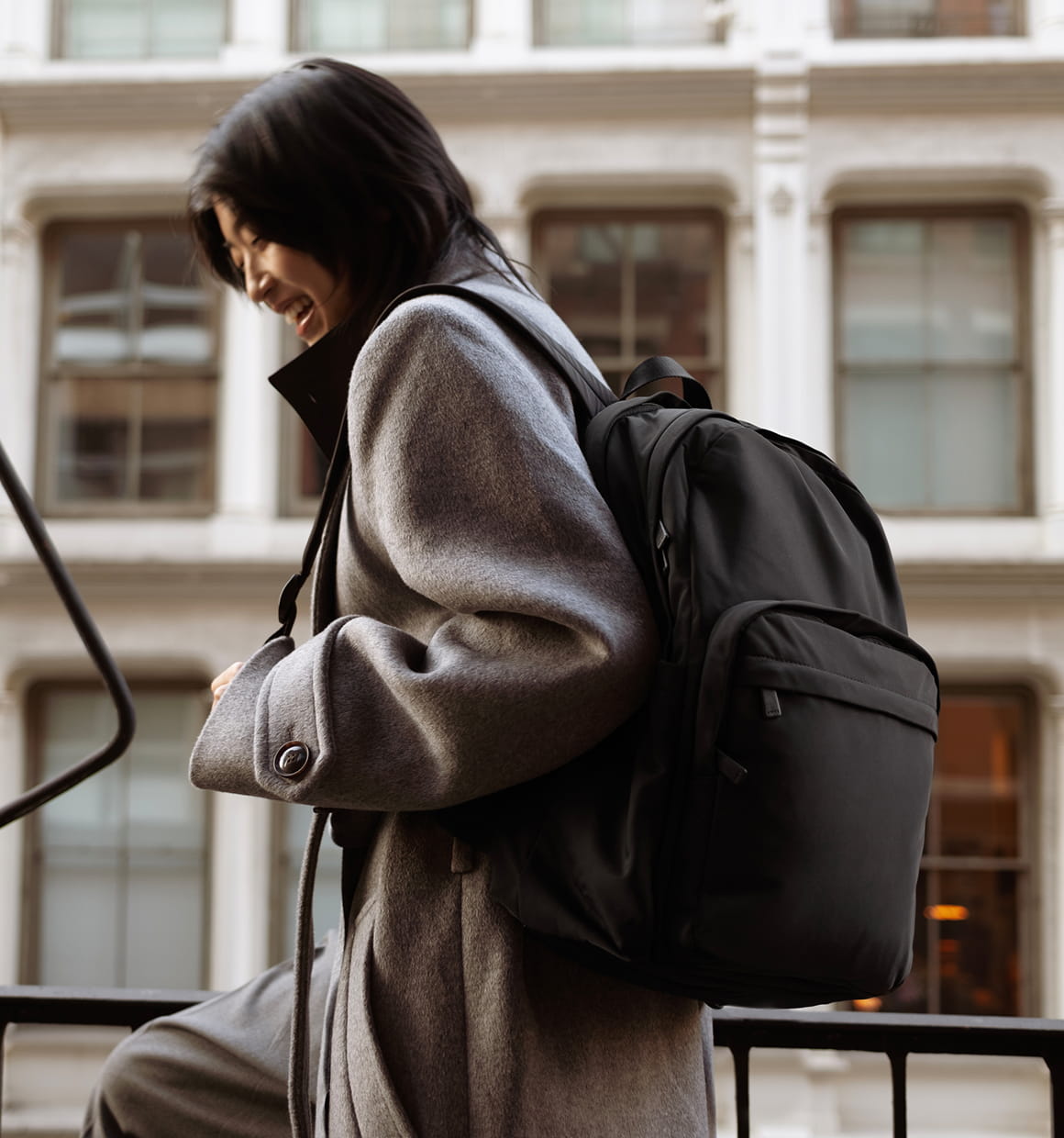 Two women posing for a photo both wearing the Away featherlight Cargo Pack