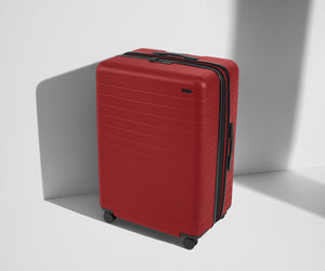 Angled product view of The Large Flex suitcase in Tango Red