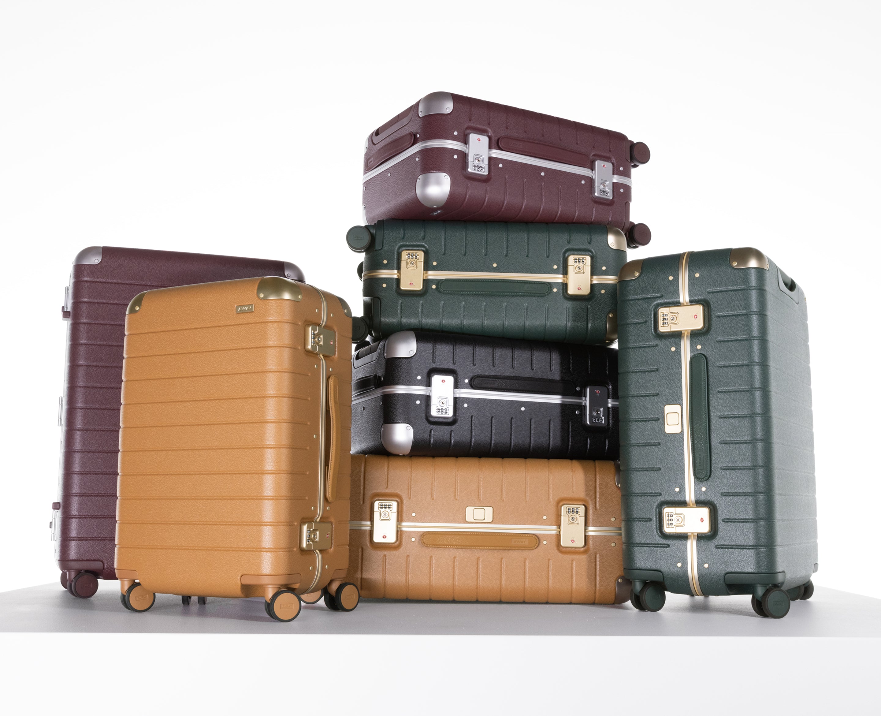 Stack of suitcases in various colors on a white background
