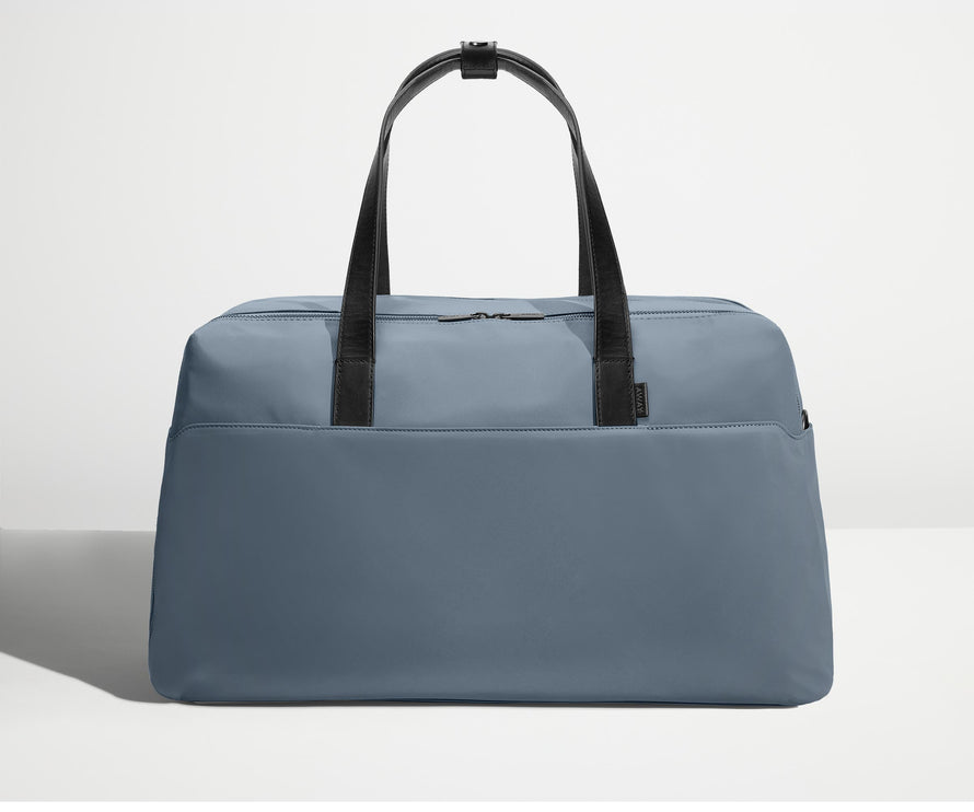 Front view of Away's Weekender duffle in Coast Blue with handles up