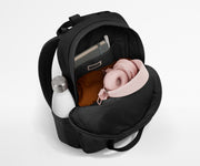Featherlight Backpack packed with a sweater, notebook, headphones, and water bottle