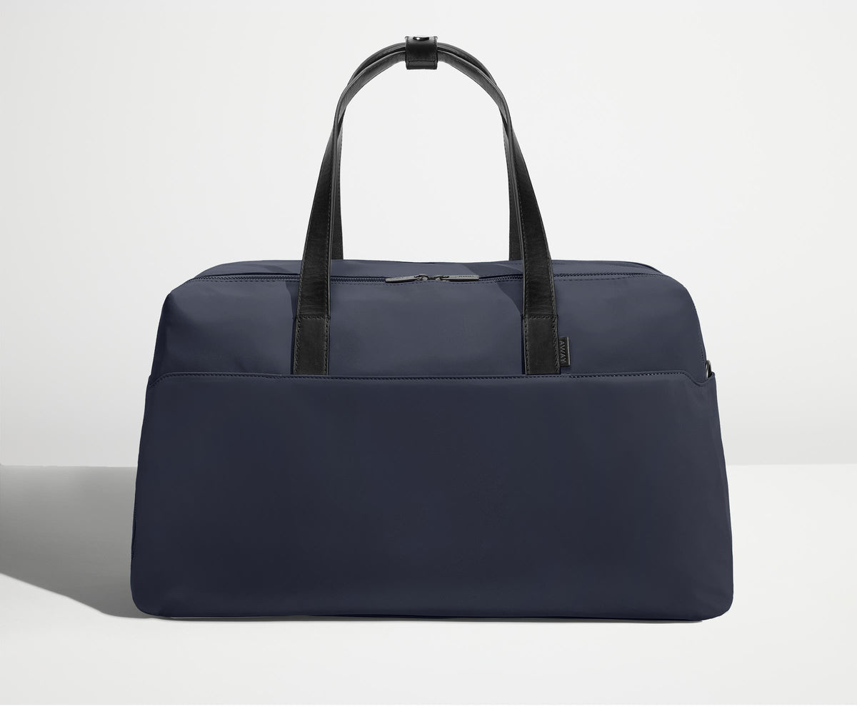 Front view of Away's Weekender duffle in Navy Blue with handles up