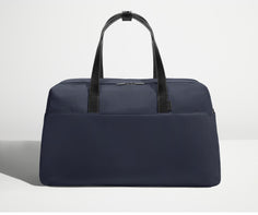 Front view of Away's Weekender duffle in Navy Blue with handles up