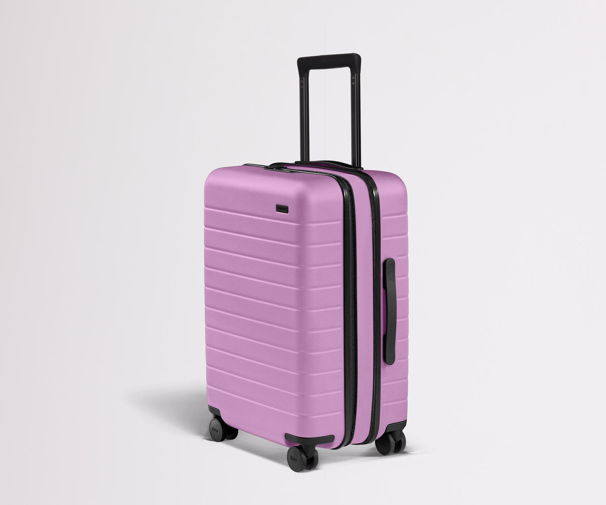 Angled product view of The Bigger Carry-On Flex suitcase in Taffy Purple