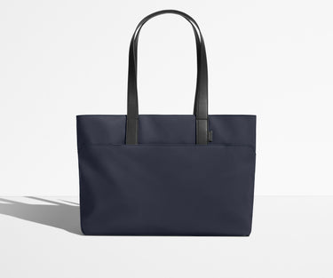 Front view of The Everywhere Tote with its leather handles up